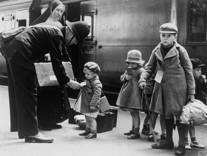 A British policeman assists child evacuees at a London railway station during World War II (1939–1945), Imperial War Museums, UK