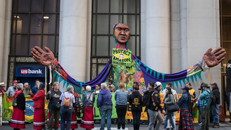 A giant puppet, street mural, and road blockade outside the Brazilian Consulate in San Francisco, California, call on President Jair Bolsonaro to protect the Amazon and respect Indigenous rights
