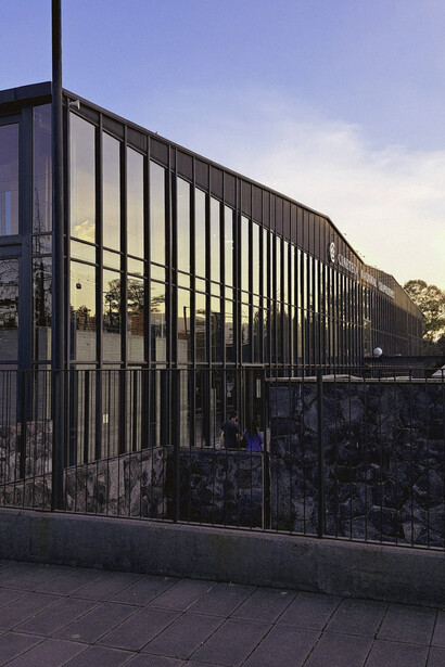 The glass façade of Cineteca Nacional Chapultepec, Mexico City, Mexico, reflecting the fusion of contemporary architecture and the surrounding natural landscape