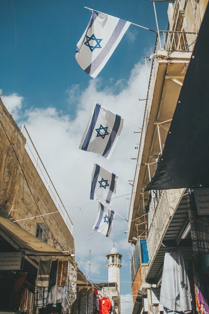 Israeli flags hanging between buildings