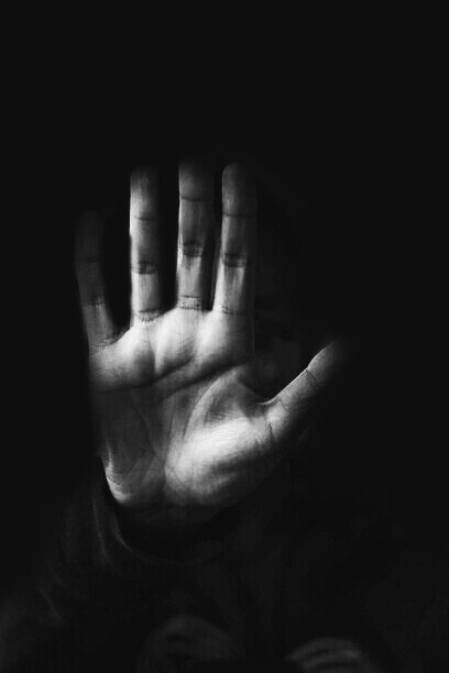 A hand stopping people from taking the wrong path