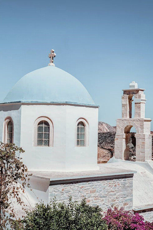 Traditional Greek church featuring a striking white façade and a beautiful blue dome in Naxos, Greece