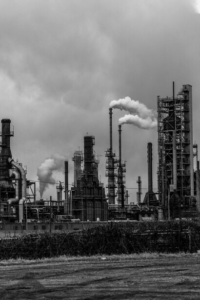 Black and white image of smoke coming out from a power plant