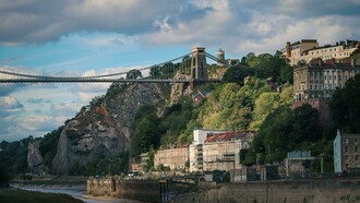 Bristol, England, United Kingdom – a bridge spanning the river against a town and mountain landscape