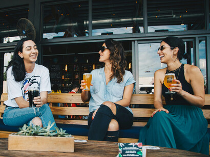 A group of friends chatting while drinking a beer
