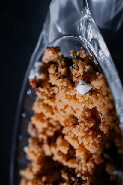 The fine, fluffy texture of couscous highlights its role as a versatile base for traditional Moroccan dishes like Rfissa, rich in flavour and history