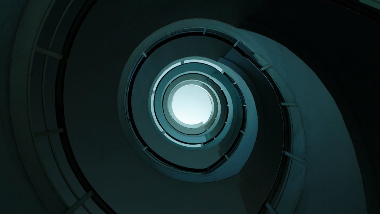 Like the spiral staircase, the pursuit of knowledge is an endless journey, where each step reveals new insights, pushing experts to continuously seek answers and challenge existing understanding