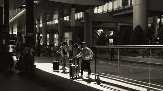 People arriving and departing with suitcases, representing the human movement behind economic growth