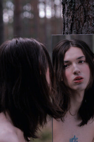 Exploring the tension between reality and aspiration, where the mirror unveils the struggle of wanting to redefine our identity