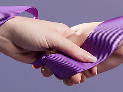 Women hands holding purple satin ribbon
