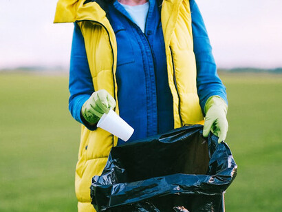 With sleeves rolled up and determination in her eyes, an eco-conscious individual shows that every small action counts in the fight against environmental degradation