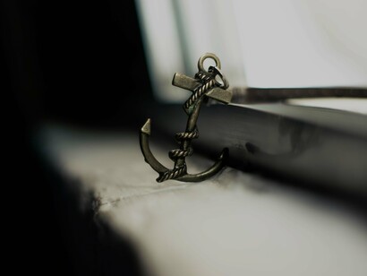 Anchor styled keychain abandoned on shabby windowsill