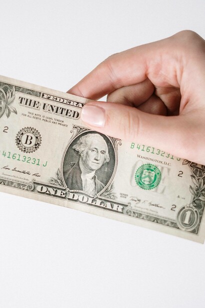 A dollar being passed forward