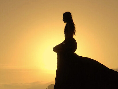 In the tranquil glow of sunset, she connects with her inner self, revealing that true peace and clarity lie within each of us