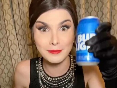 Transgender female Dylan Mulvaney showcasing her own personalised beer cans of Bud Light
