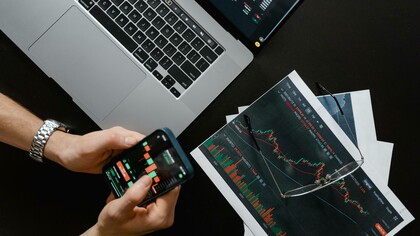 Man navigates investment options on his phone