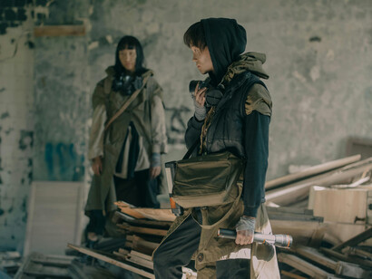 A young man and woman in a post apocalyptic world