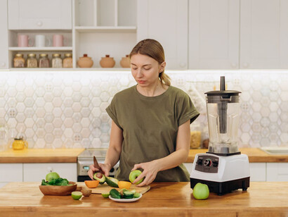 Witness the art of wellness as a woman crafts a spirulina-infused energy bite, combining natural ingredients like dates and nuts to boost energy levels and support immune health