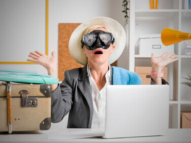 Office scene: middle-aged businesswoman reflecting on her upcoming summer break