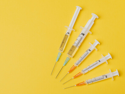 Several syringes arranged in an arc