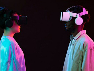 A young woman and man wearing VR glasses