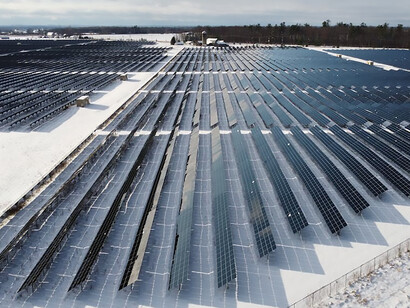 In the pristine winter landscape of Ontario, Canada, clean energy takes center stage as solar panels gracefully adorn the snow, capturing the power of the sun to illuminate the snowy terrain