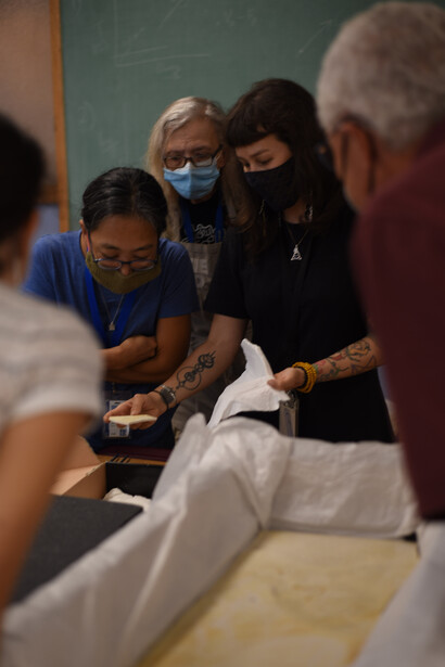 Left to right, Akiko Shinya,
Connie Van Beek, and
Jingmai O’Connor unpacking
the fossil in August 2022. Courtesy of Field Museum