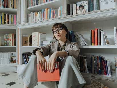 A girl holding a book in a library