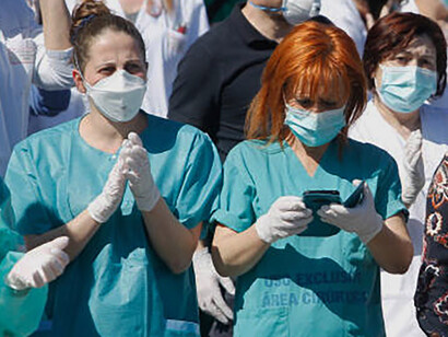 A group of health workers protesting, demonstrating medical activism and advocating for healthcare rights, Spain