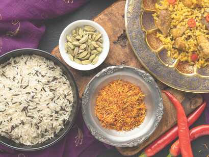 The exhibit presents a captivating blend of Indian saris and Indian cuisine, highlighting the rich traditions of both fashion and food
