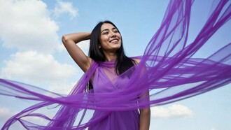 A woman at ease as fabric moves with the wind, symbolizing the freedom of becoming emotionally whole