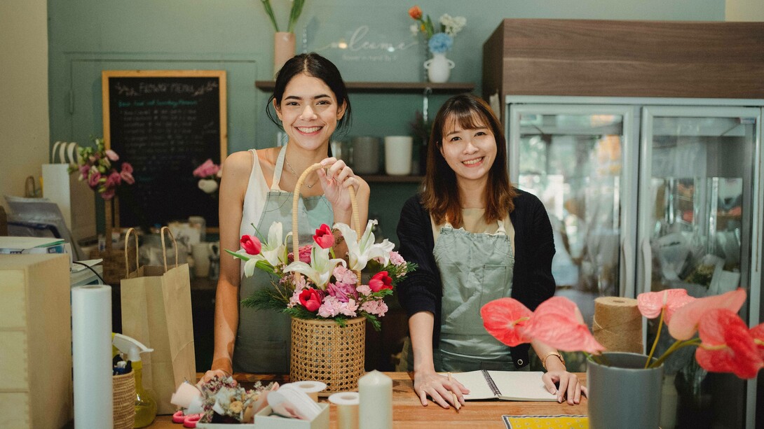 Two women working in their flower shop as part of achieving their soul-aligned business