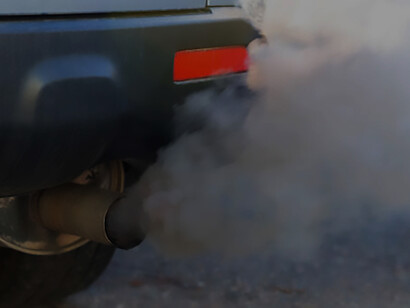 Highlighting the urgency of the city's air pollution crisis, this image captures a diesel vehicle exhaust pipe emitting harmful emissions on a highway, emphasizing the need for environmental awareness and sustainable transportation solutions