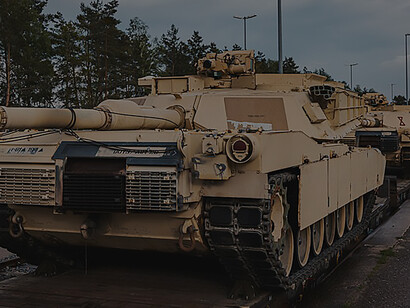 Awaiting offloading at Grafenwoehr, Germany, essential U.S. M1A1 Abrams tanks for Armed Forces training in Ukraine