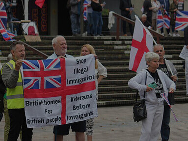 Far-right protesters rally in Portsmouth, United Kingdom, demonstrating their opposition with provocative displays