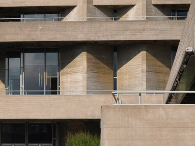 The National Theatre in London, England, has a robust design that not only serves as a performing arts venue but also illustrates how Brutalist architecture can adapt to modern sustainability practices