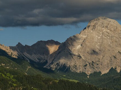 The contours of the human experience, interchangeable with the lines of the mountain face, the silhouette shimmering in the distance