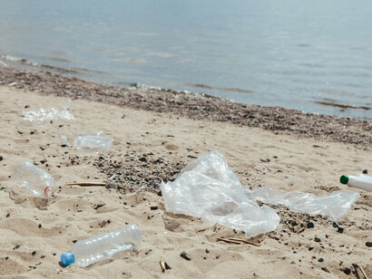 A close up of a beach filled with garbage