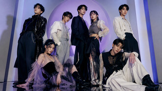 A K-pop-inspired group styled in layered monochrome looks, representing the theatrical fashion narratives central to idol culture
