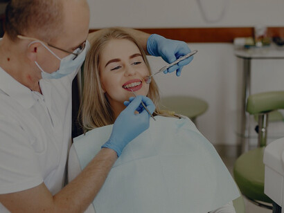 Girl in the dentist’s chair, showcasing the significance of a well-balanced oral microbiome for achieving and maintaining healthy teeth and gums