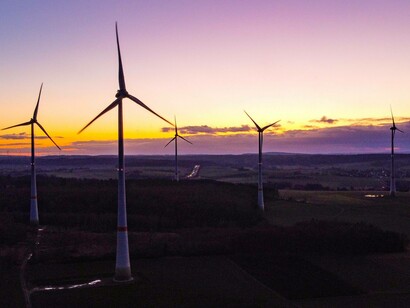 A row of windmills whose purpose is to provide efficient energy