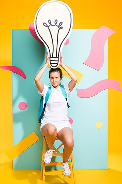 The spirit of creativity in a captivating image of a schoolgirl holding a large light bulb, representing the spark of inspiration and imaginative potential