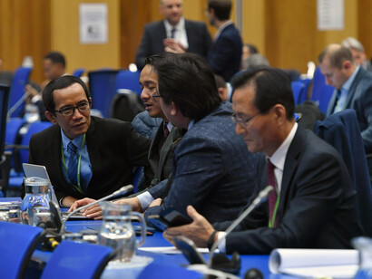 Officials having a conversation at the 2019 International Conference on Climate Change