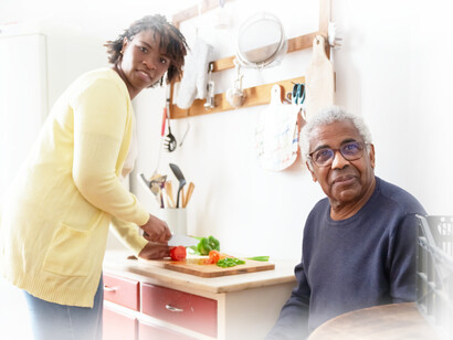 A daughter makes sure her father, who has been diagnosed with the beginning stages of AD, has a healthy meal