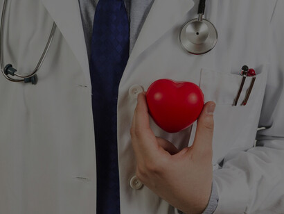A healthcare professional holding a plastic heart, representing the impact of positive thinking on cardiovascular health and overall mental health
