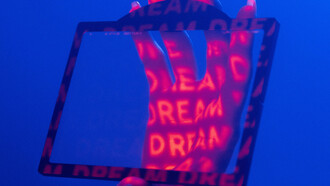 A hand within a frame, word projected into it