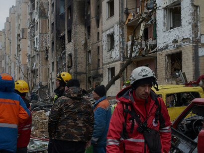 On January 2, 2024, in Kyiv, Ukraine, a Russian missile strike has severely damaged a residential building. Emergency responders, including rescuers and firefighters, are working to assist civilians and combat the fire