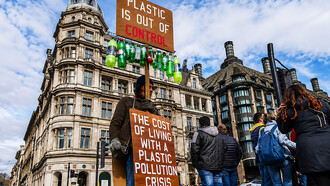 Plastic pollution activist holding a protest sign during a climate change demonstration