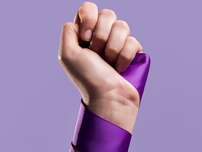 Front view of a woman's fist with ribbon