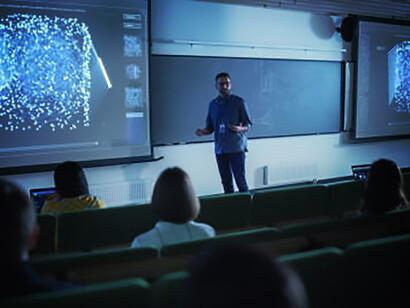 Young university professor discussing quantum information theory, stochastic resonance, multidimensional scaling, and quantum computing